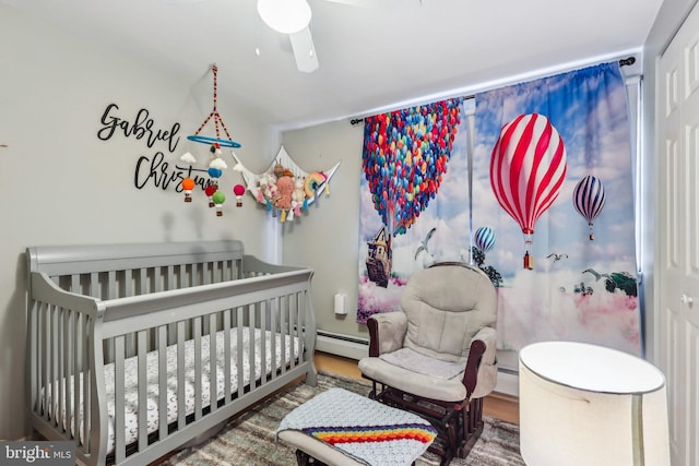 228 Balligomingo Rd, Conshohocken, PA 19428 - bedroom featuring a crib, a baseboard heating unit, and ceiling fan