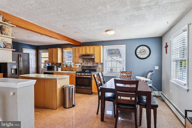 228 Balligomingo Rd, Conshohocken, PA 19428 - kitchen featuring stainless steel appliances, under cabinet range hood, a kitchen island, granite tiled floors, and light countertops