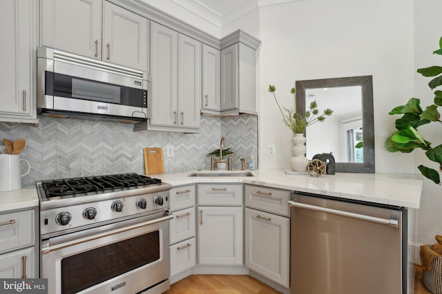 408 M St NW Unit 4, Washington, DC 20001 - kitchen featuring appliances with stainless steel finishes, a sink, tasteful backsplash, and light wood-style floors