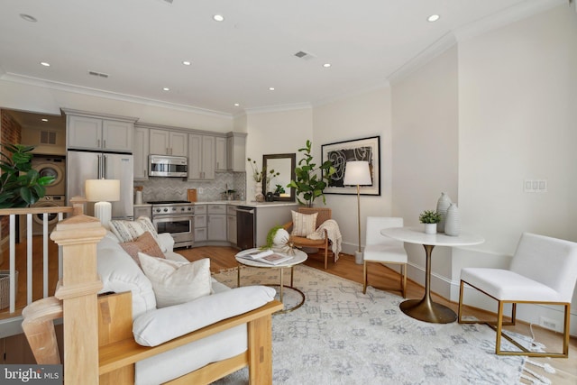 408 M St NW Unit 4, Washington, DC 20001 - living area featuring ornamental molding, recessed lighting, light wood finished floors, washer / clothes dryer, and baseboards