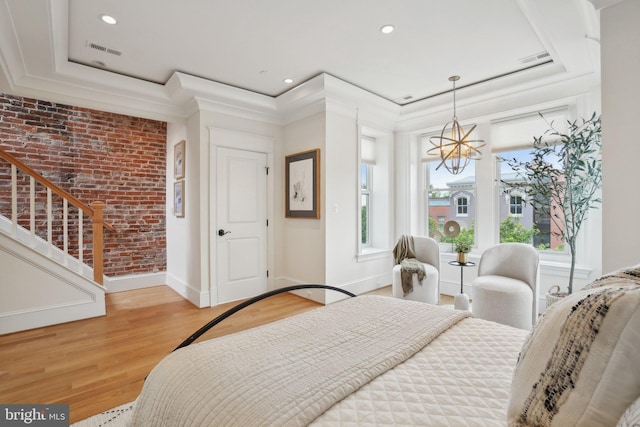 408 M St NW Unit 4, Washington, DC 20001 - bedroom with baseboards, light wood finished floors, brick wall, a chandelier, and ornamental molding