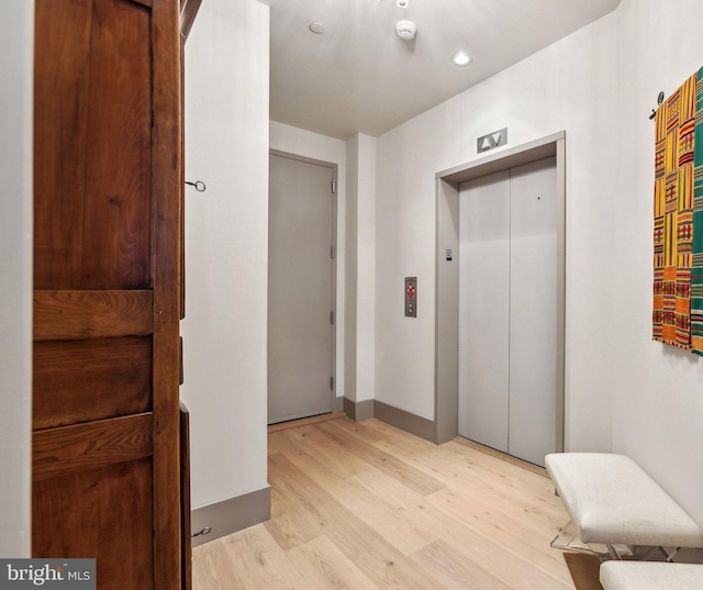 1881 N Nash St Unit 2309, Arlington, VA 22209 - hall with elevator, light wood-style flooring, baseboards, and recessed lighting