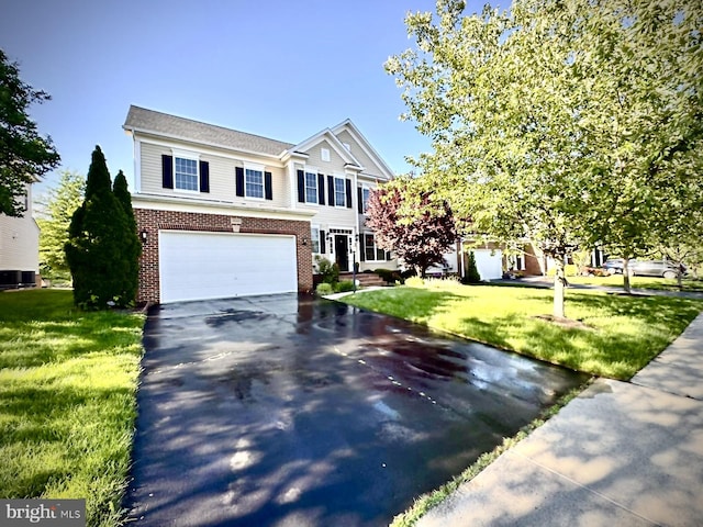 42322 Rising Moon Pl, Brambleton, VA 20148 - view of front of home featuring asphalt driveway, an attached garage, brick siding, and a front yard