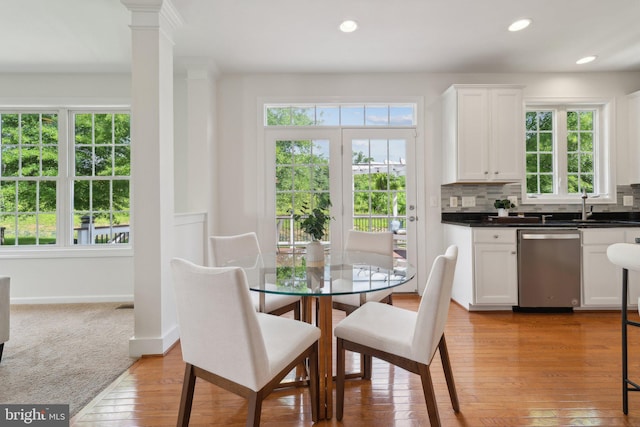 42322 Rising Moon Pl, Brambleton, VA 20148 - dining room with healthy amount of natural light, light wood-style flooring, recessed lighting, baseboards, and decorative columns