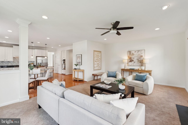 42322 Rising Moon Pl, Brambleton, VA 20148 - living room featuring ceiling fan, recessed lighting, light colored carpet, decorative columns, and baseboards