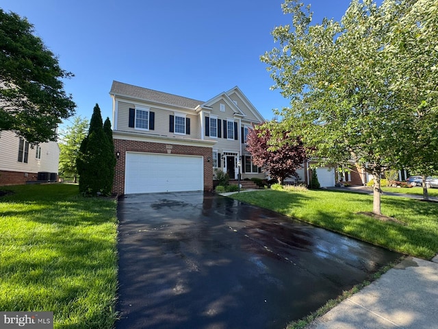 42322 Rising Moon Pl, Brambleton, VA 20148 - view of front of house with driveway, brick siding, a garage, and a front lawn