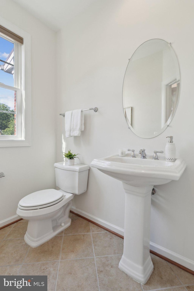 42322 Rising Moon Pl, Brambleton, VA 20148 - half bathroom featuring baseboards, toilet, tile patterned floors, and a sink
