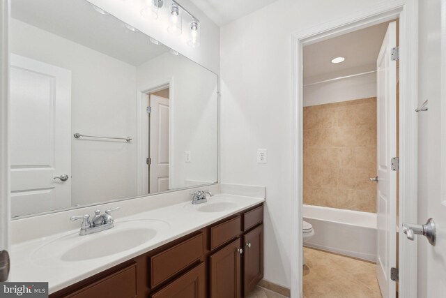 42322 Rising Moon Pl, Brambleton, VA 20148 - bathroom featuring double vanity, toilet, tub / shower combination, tile patterned floors, and baseboards