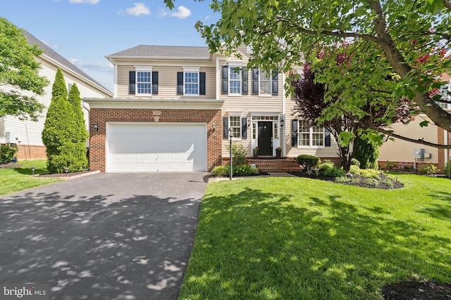 42322 Rising Moon Pl, Brambleton, VA 20148 - view of front of home with asphalt driveway, an attached garage, a front lawn, and brick siding
