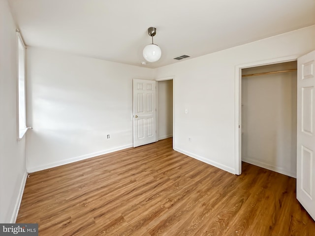 2426 Jefferson St, Baltimore, MD 21205 - unfurnished bedroom with a closet, light wood-style floors, and baseboards