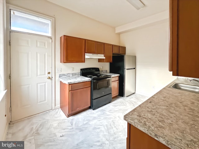 2426 Jefferson St, Baltimore, MD 21205 - kitchen with black range with electric stovetop, under cabinet range hood, freestanding refrigerator, brown cabinetry, and a sink