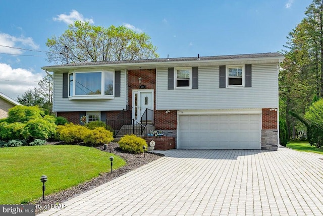 691 Harvey St, West Hazleton, PA 18202 - split foyer home with an attached garage, brick siding, driveway, and a front yard