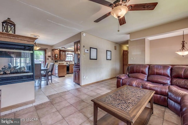 691 Harvey St, West Hazleton, PA 18202 - living area with ceiling fan, light tile patterned floors, and baseboards