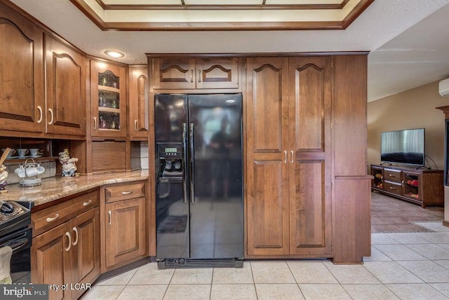 691 Harvey St, West Hazleton, PA 18202 - kitchen featuring black appliances, brown cabinets, light stone countertops, light tile patterned floors, and glass insert cabinets