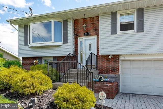 691 Harvey St, West Hazleton, PA 18202 - view of front of house featuring brick siding and an attached garage