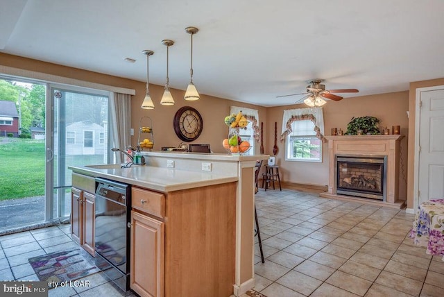 691 Harvey St, West Hazleton, PA 18202 - kitchen with black dishwasher, light countertops, a fireplace with raised hearth, and light tile patterned floors