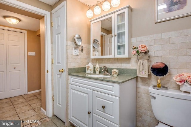 691 Harvey St, West Hazleton, PA 18202 - bathroom featuring tile patterned flooring, vanity, toilet, and tile walls