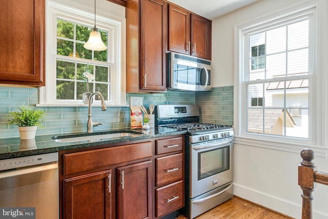970 N Longfellow St, Arlington, VA 22205 - kitchen with stainless steel appliances, dark stone counters, and backsplash