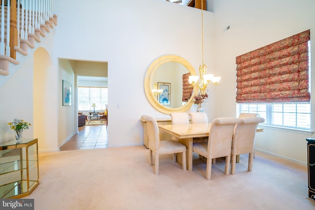 6 Galileo Dr, Cranbury, NJ 08512 - dining space featuring carpet flooring, a chandelier, a high ceiling, plenty of natural light, and baseboards