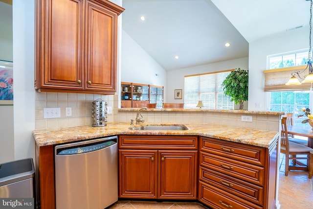 6 Galileo Dr, Cranbury, NJ 08512 - kitchen featuring stainless steel dishwasher, a sink, light stone counters, brown cabinets, and tasteful backsplash