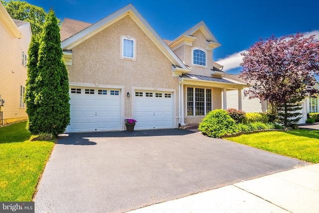 6 Galileo Dr, Cranbury, NJ 08512 - traditional home with asphalt driveway, a standing seam roof, a garage, stucco siding, and a front yard