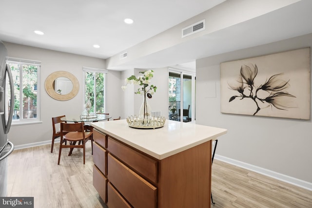 5050 7th Rd S Unit 201, Arlington, VA 22204 - kitchen featuring a kitchen island, light wood-type flooring, baseboards, light countertops, and recessed lighting
