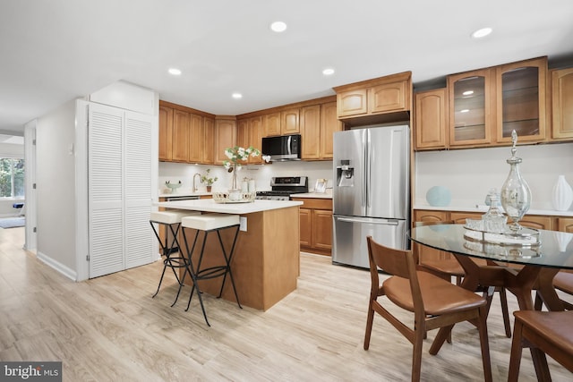 5050 7th Rd S Unit 201, Arlington, VA 22204 - kitchen with appliances with stainless steel finishes, light countertops, light wood finished floors, a center island, and recessed lighting