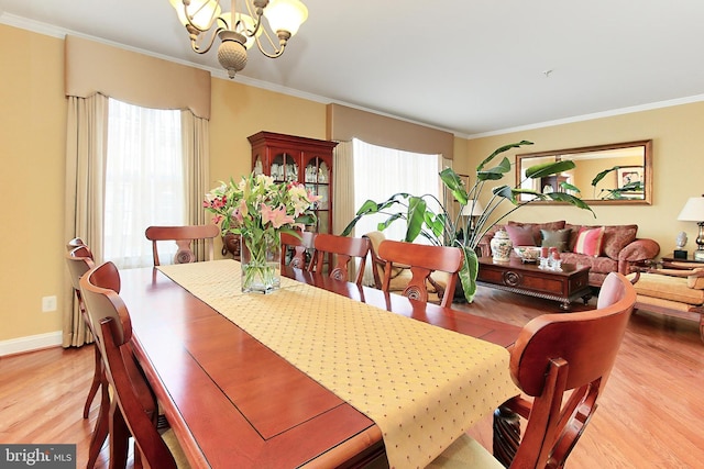 120 Fortnightly Blvd, Herndon, VA 20170 - dining room featuring light wood finished floors, a chandelier, ornamental molding, and baseboards