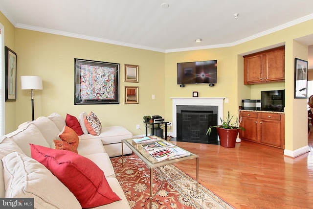 120 Fortnightly Blvd, Herndon, VA 20170 - living room featuring light wood finished floors, crown molding, a fireplace with flush hearth, and baseboards