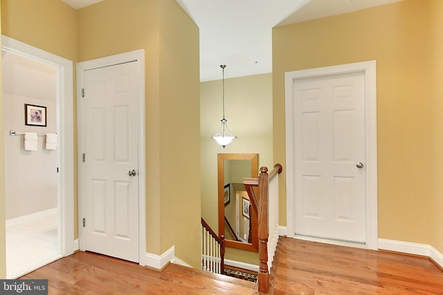 120 Fortnightly Blvd, Herndon, VA 20170 - hall with an upstairs landing, light wood-style floors, and baseboards