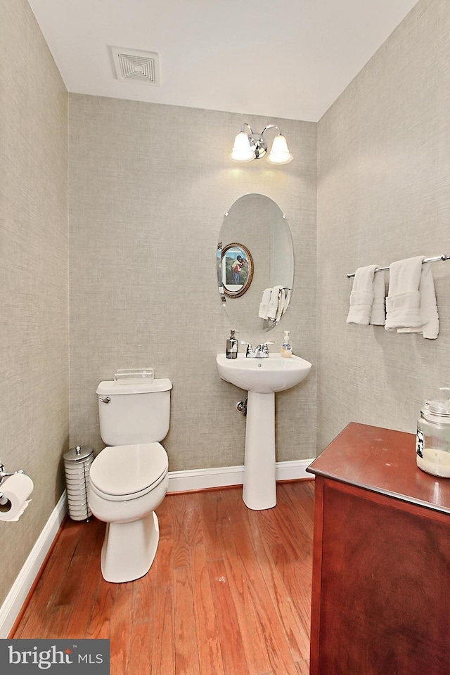 120 Fortnightly Blvd, Herndon, VA 20170 - half bath with wood finished floors, toilet, baseboards, and a sink