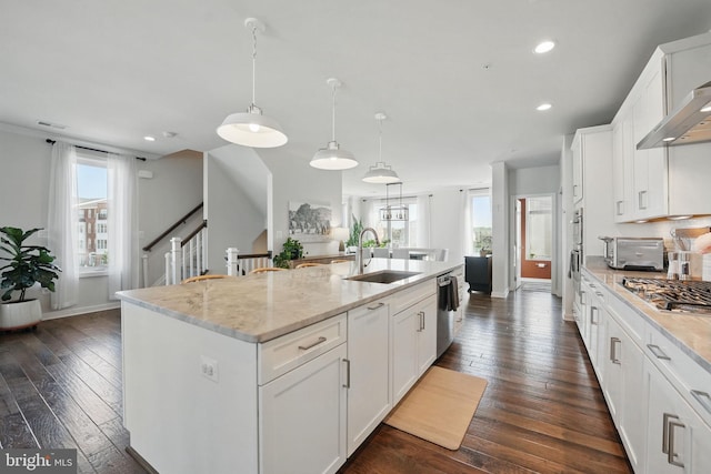 kitchen featuring a sink, stainless steel appliances, dark wood finished floors, white cabinets, and recessed lighting