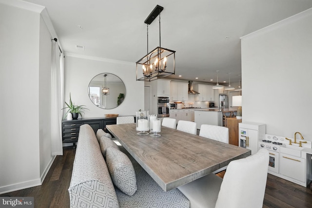 dining room featuring a chandelier, ornamental molding, dark wood finished floors, baseboards, and recessed lighting