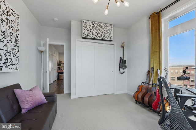 living area featuring carpet and baseboards