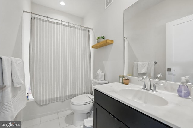 full bath featuring toilet, vanity, tile patterned floors, and shower / tub combo