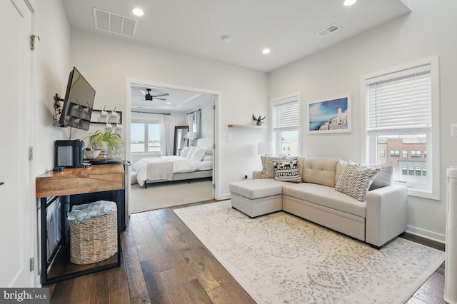 living area with hardwood / wood-style flooring, recessed lighting, a ceiling fan, and baseboards