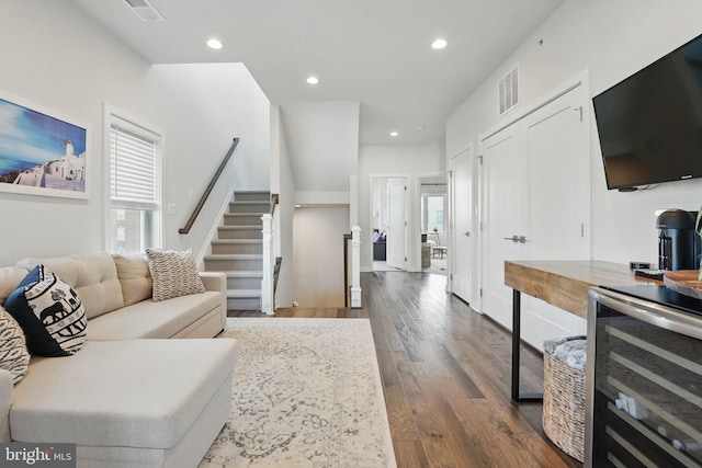 living room featuring wine cooler, stairs, dark wood-type flooring, and recessed lighting