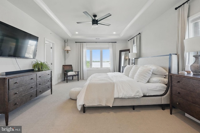 bedroom featuring a tray ceiling, carpet floors, recessed lighting, and ceiling fan
