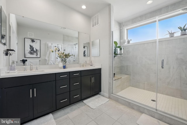 full bathroom featuring a shower stall, double vanity, tile patterned flooring, and recessed lighting