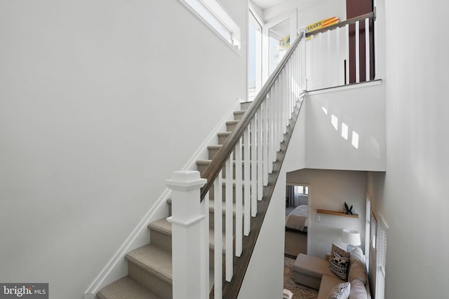 stairs featuring a high ceiling