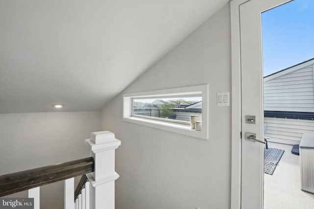 corridor featuring an upstairs landing, vaulted ceiling, and recessed lighting