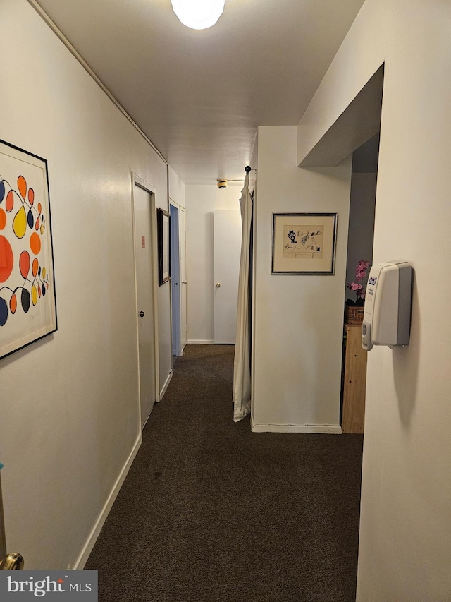 5410 Connecticut Ave NW Unit 112, Washington, DC 20015 - corridor featuring dark colored carpet and baseboards