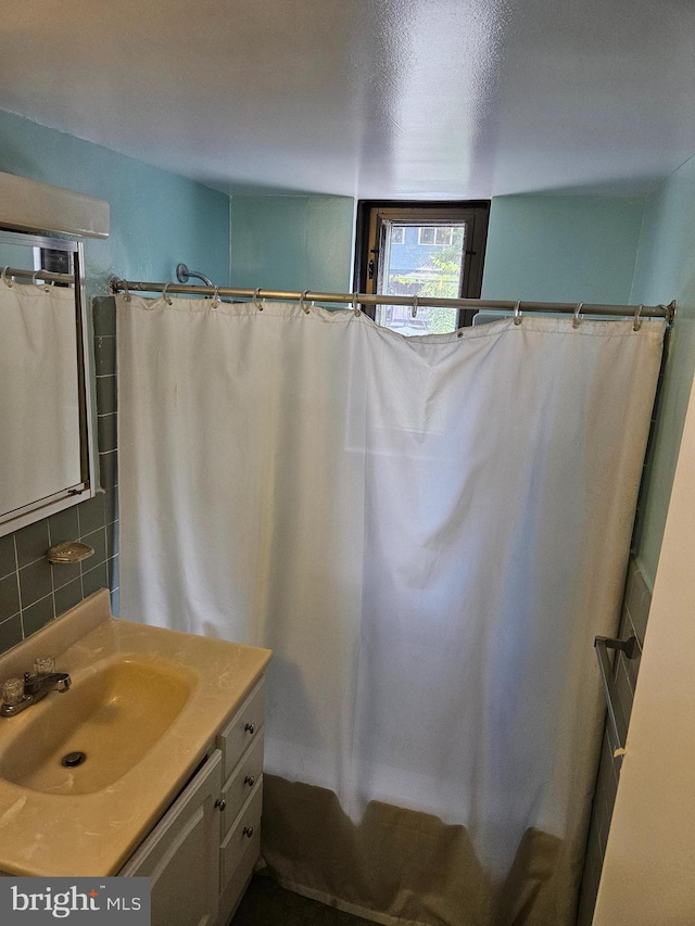 5410 Connecticut Ave NW Unit 112, Washington, DC 20015 - bathroom with vanity, backsplash, and curtained shower