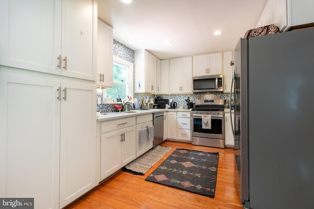 618 Chapelgate Dr, Odenton, MD 21113 - kitchen with stainless steel appliances, light wood finished floors, white cabinetry, decorative backsplash, and recessed lighting