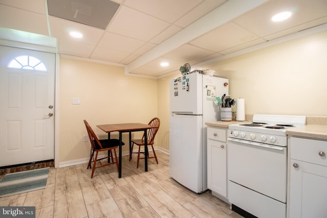 618 Chapelgate Dr, Odenton, MD 21113 - kitchen featuring white appliances, light countertops, white cabinets, recessed lighting, and light wood-type flooring