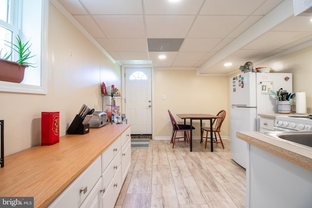 618 Chapelgate Dr, Odenton, MD 21113 - kitchen with white cabinets, light countertops, a drop ceiling, recessed lighting, and light wood-type flooring