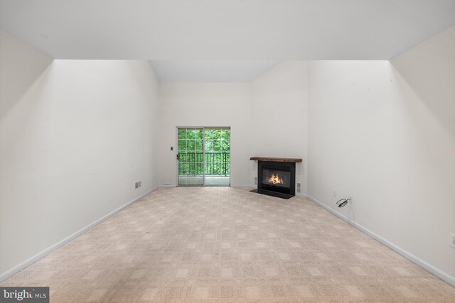 355 Westridge Cir Unit 128, Phoenixville, PA 19460 - unfurnished living room with a fireplace with flush hearth, carpet, and baseboards