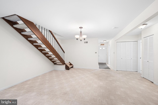 355 Westridge Cir Unit 128, Phoenixville, PA 19460 - unfurnished living room with a chandelier, stairs, baseboards, and carpet flooring
