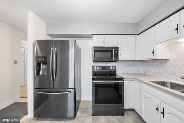 355 Westridge Cir Unit 128, Phoenixville, PA 19460 - kitchen with appliances with stainless steel finishes, white cabinets, light tile patterned flooring, and light countertops