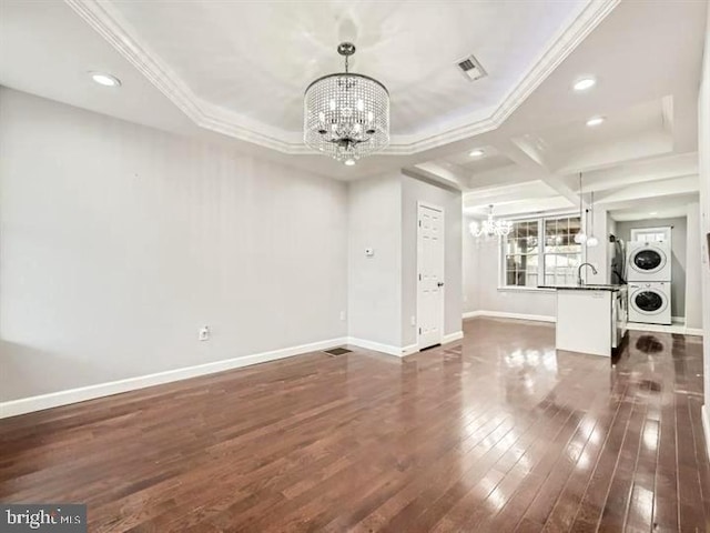 905 E Patapsco Ave, Baltimore, MD 21225 - unfurnished living room with a chandelier, estacked washer and dryer, a sink, ornamental molding, and recessed lighting